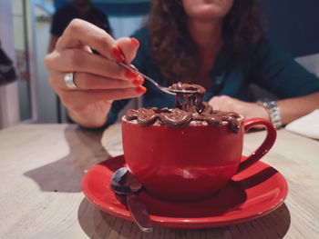 Close-up of woman with ice cream on table