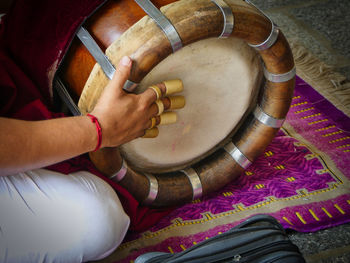 Close-up of man hand playing drum