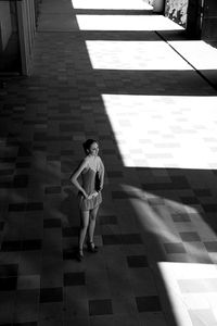 Woman standing on footpath