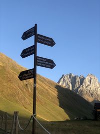 Information sign on landscape against clear sky