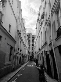 Narrow street amidst buildings in city