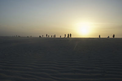 Silhouette of people at sunset