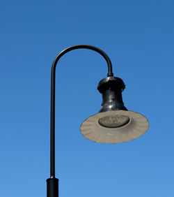 Low angle view of street light against clear blue sky