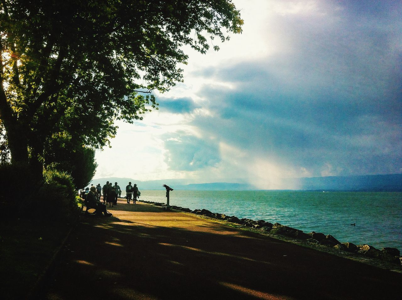 sky, water, sea, cloud - sky, horizon over water, tranquility, tranquil scene, scenics, cloudy, beauty in nature, beach, nature, silhouette, cloud, shore, tree, weather, idyllic, outdoors, overcast