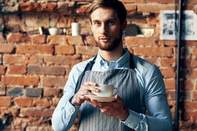 Portrait of young man drinking coffee