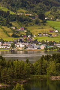 Houses by lake against sky