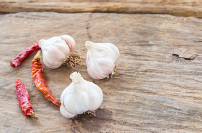 Garlic and dry chili on wooden table background