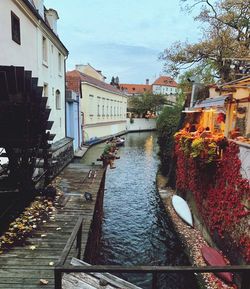 Canal amidst buildings against sky