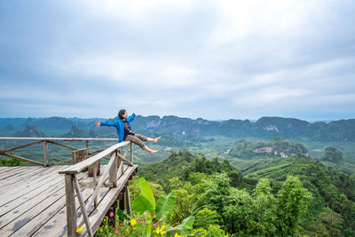 Man looking at mountain against sky