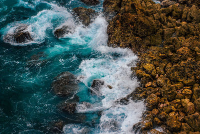High angle view of water flowing through rocks
