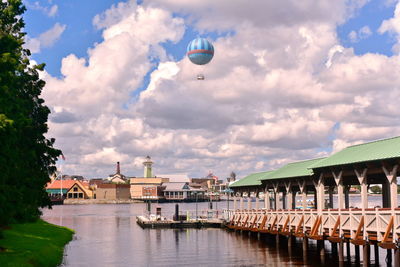 View of buildings at waterfront against cloudy sky