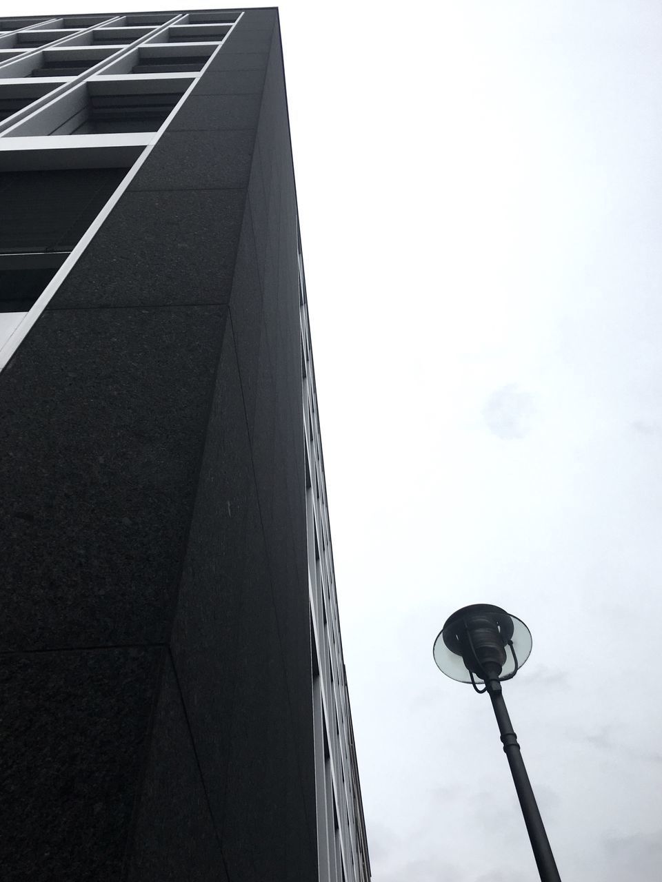 LOW ANGLE VIEW OF STREET LIGHT AND BUILDINGS AGAINST SKY