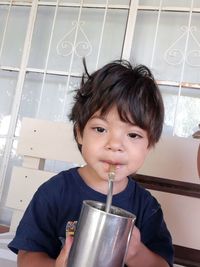 Portrait of cute boy holding camera