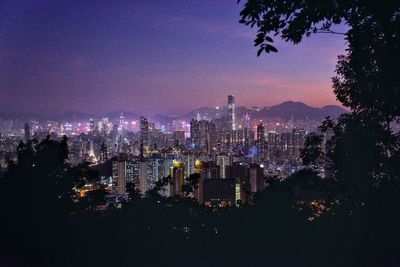 High angle view of illuminated buildings against sky at night