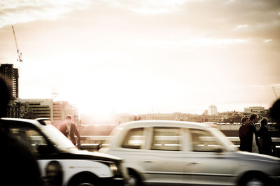 Cars on road at sunset