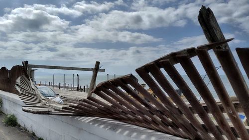 Low angle view of abandoned roof against sky