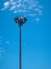 Low angle view of street light against blue sky