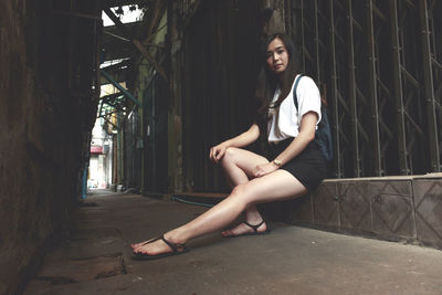 Portrait of young woman sitting outdoors