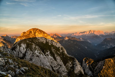 Scenic view of snowcapped mountains against sky during sunset