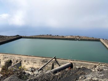 High angle view of metal structure by sea against sky