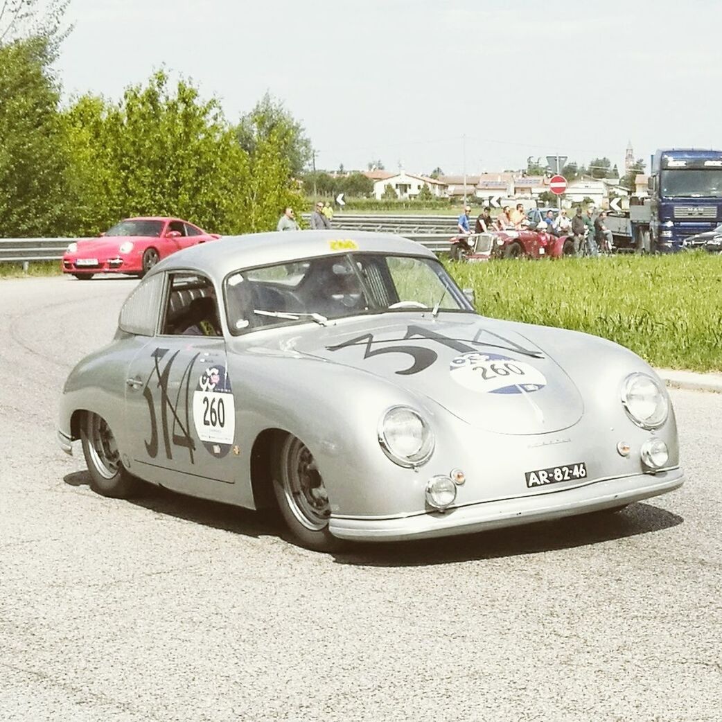 car, transportation, land vehicle, day, outdoors, mode of transport, no people, architecture, tree, close-up, sports race, sky