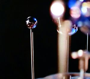 Close-up of hand with illuminated lighting equipment at night