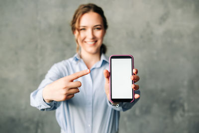 Portrait of young woman using mobile phone