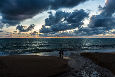 Scenic view of calm sea at sunset