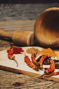 Spices by mortar and pestle on table