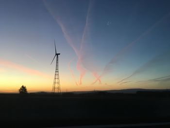 Silhouette of wind turbines at sunset