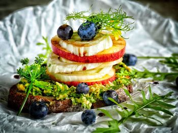 Close-up of bread with fruits and herbs