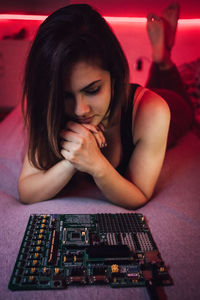 High angle view of young woman sitting on table