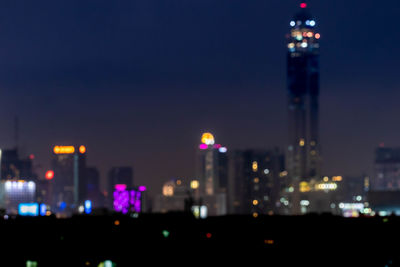 Defocused image of illuminated buildings at night