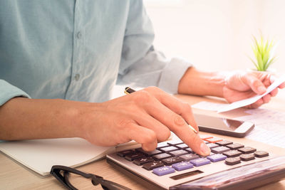 Midsection of man working on table