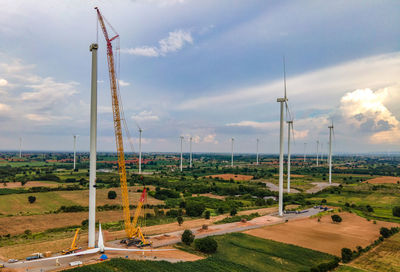 Windmill on field against sky