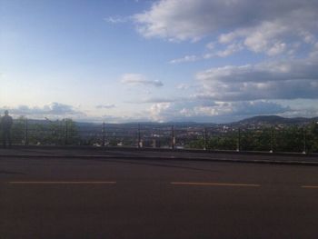 View of road against cloudy sky