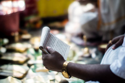 Close-up of man reading book