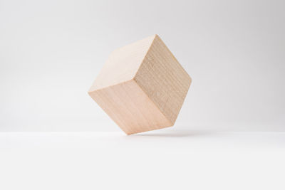 Close-up of wooden cube shape against white background