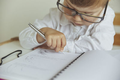 Charming child plays pretending to be a teacher