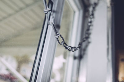 Close-up of chain in window