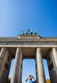 Low angle view of statue against blue sky