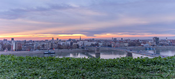 View of cityscape against cloudy sky during sunset