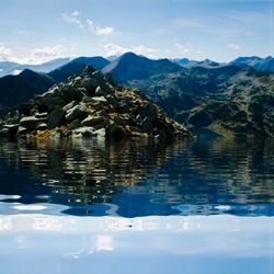 Scenic view of lake and mountains against sky