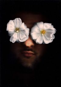 Close-up of white flower against black background