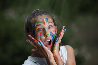 Close-up of young woman with rainbow