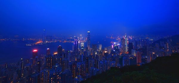 High angle view of city lit up at night