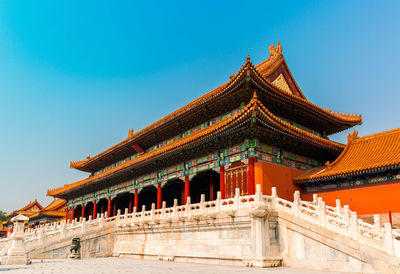 Low angle view of temple building against clear blue sky