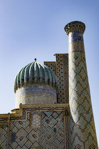 Low angle view of bell tower against clear blue sky