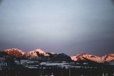 Scenic view of snowcapped mountains against sky during winter