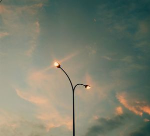 Low angle view of street light against sky at sunset